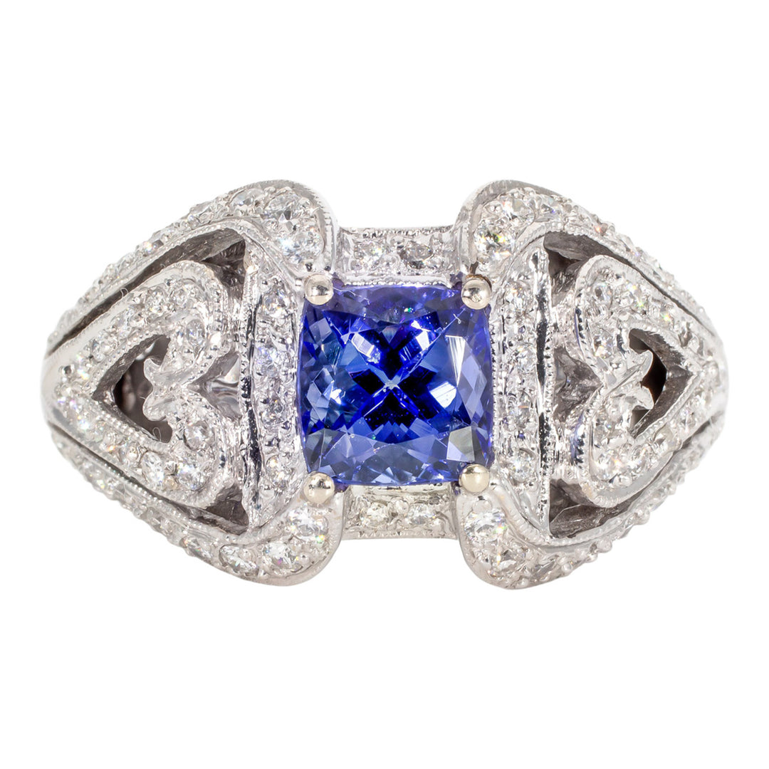 Antique style ring in 18K WG with pave set round diamonds and 4-prong set tanzanite center stone. D0.61ct.t.w. Tanzanite 1.65ct.