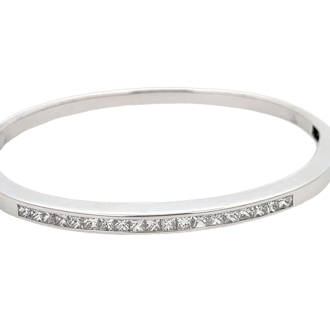 Bangle in 18K WG with channel set princess cut diamonds. D1.55ct.t.w.