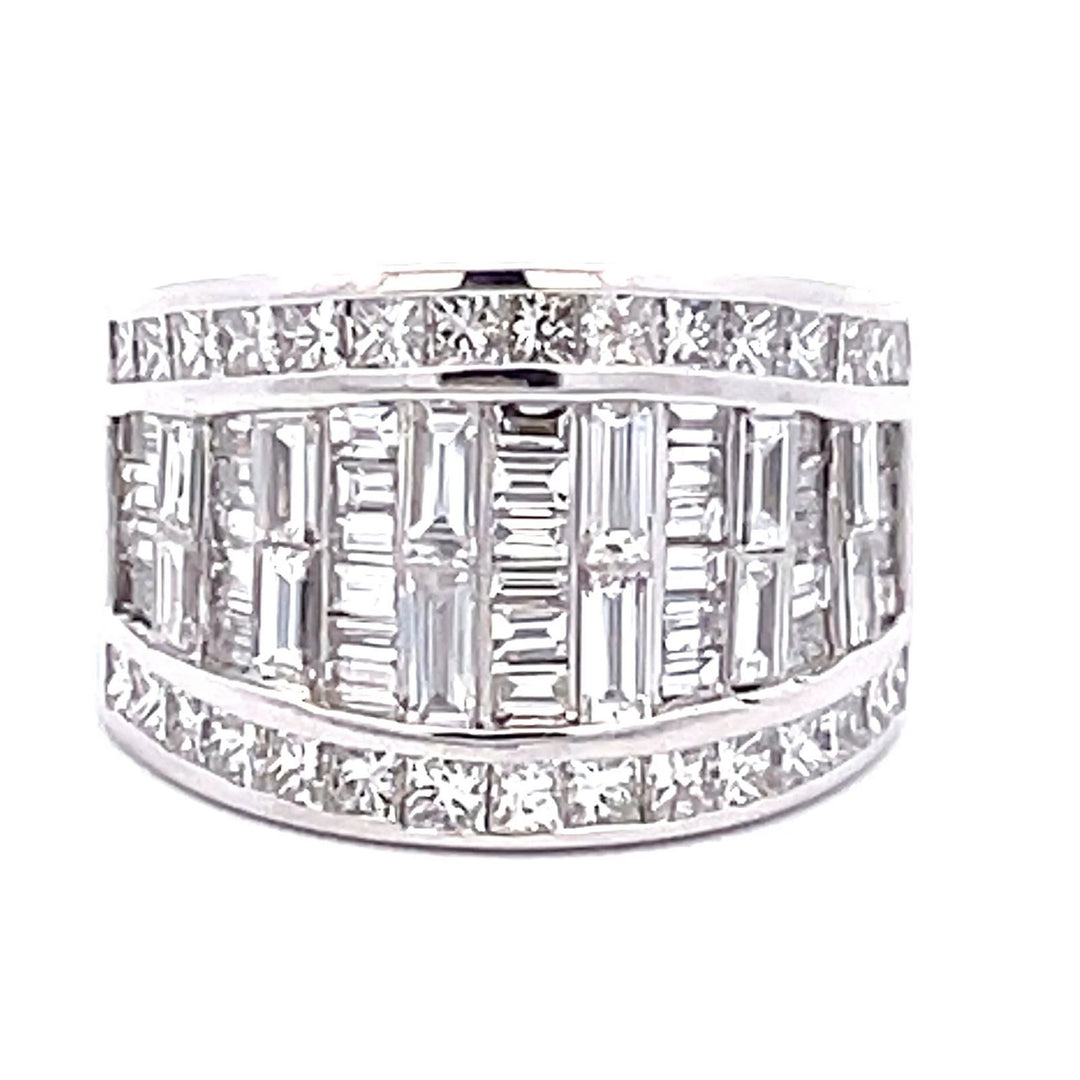 Band in 10L WG invisible set baguettes and channel set princess cut diamonds on the sides. D3.68ct.t.w. Size 5.5