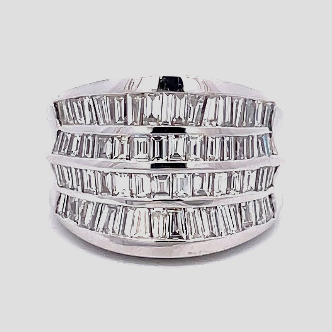Wide graduated band in 18K WG with 4-row channel set baguette diamonds D3.25ct.tw. Size 6.75