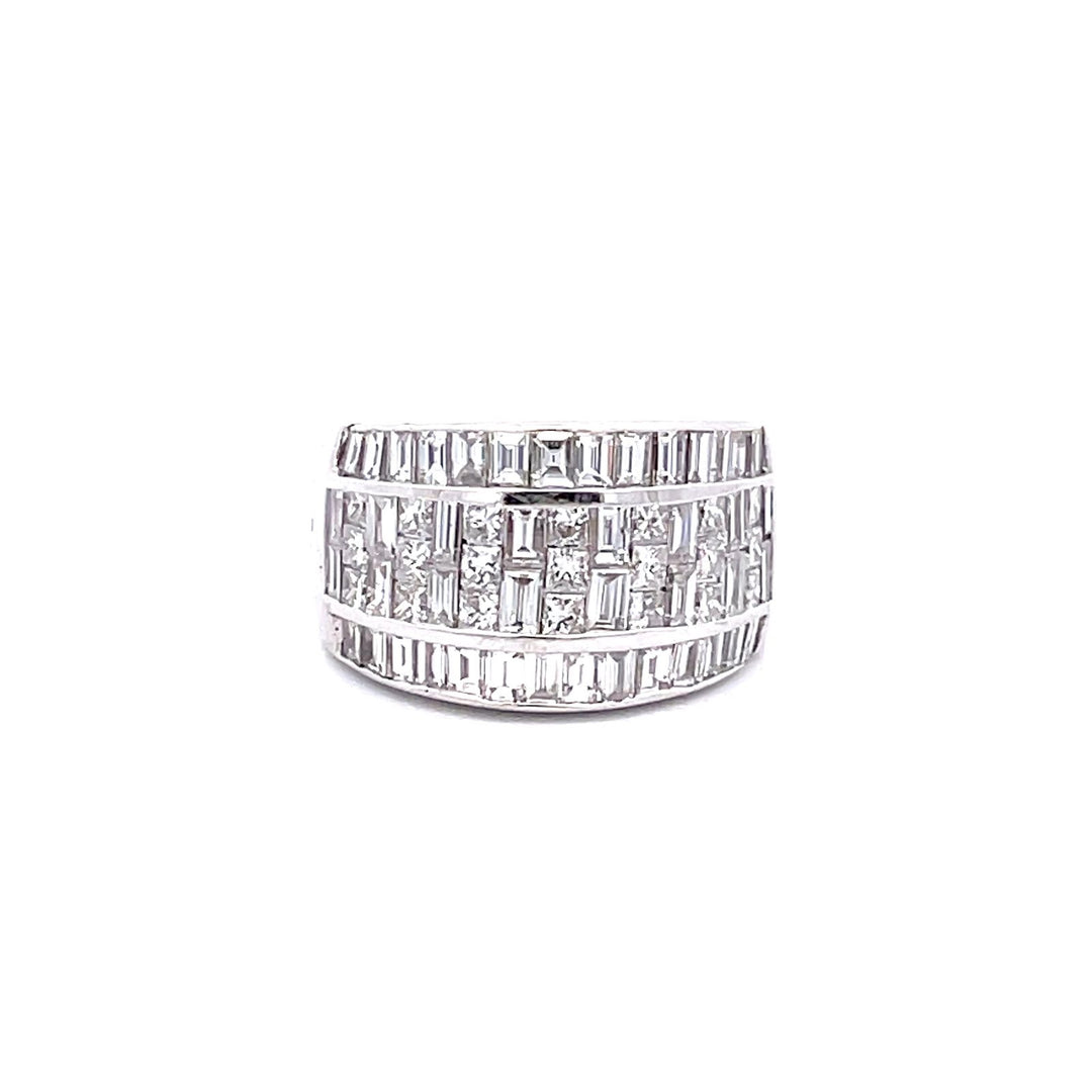 Wide band with invisible set combination princess cuts and baguettes on the center & channel set baguette diamonds on the sides. D2.87ct.t.w.