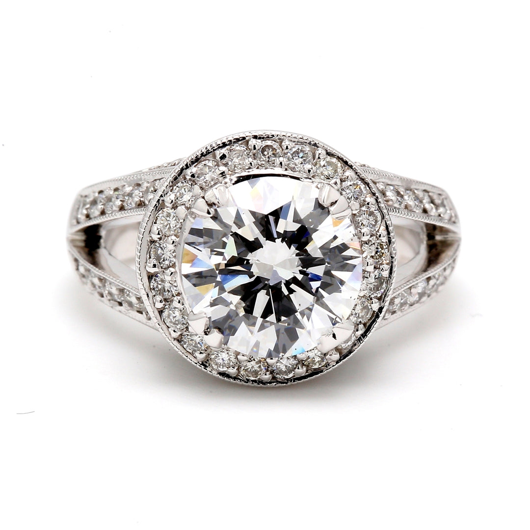 Halo split-shank semi-mount in platinum with milgrain & round diamonds. D0.71ct.t.w.