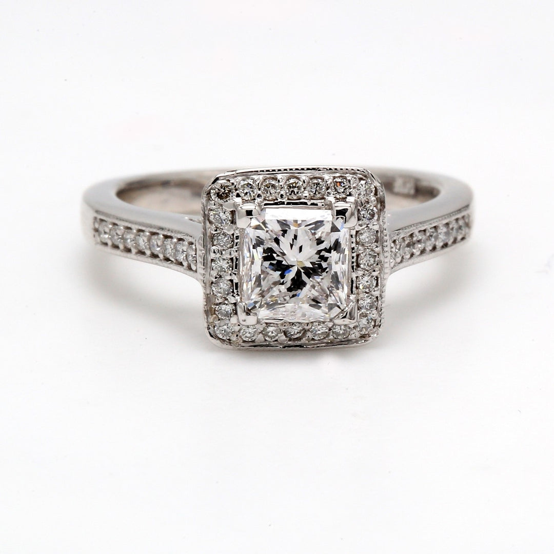 Halo ring with 4-prong set GIA certified E/SI2 radiant cut center, pave and bezel set round diamonds. D1.50ct.t.w. (Center 1.00ct.) Size 6.25