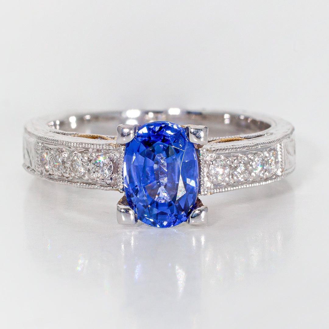 Designer ring in 18K two-tone with round diamonds & oval shaped sapphire centers. D0.15ct.t.w. Sapphire 1.47ct.