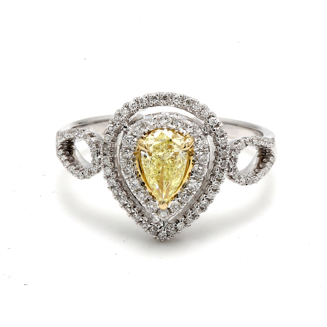 Double halo curved split-shank ring in 18K WG with French pave set rounds around a 3-prong set fancy yellow pear shape diamond center. D0.78ct.t.w. (Center 0.51ct.)