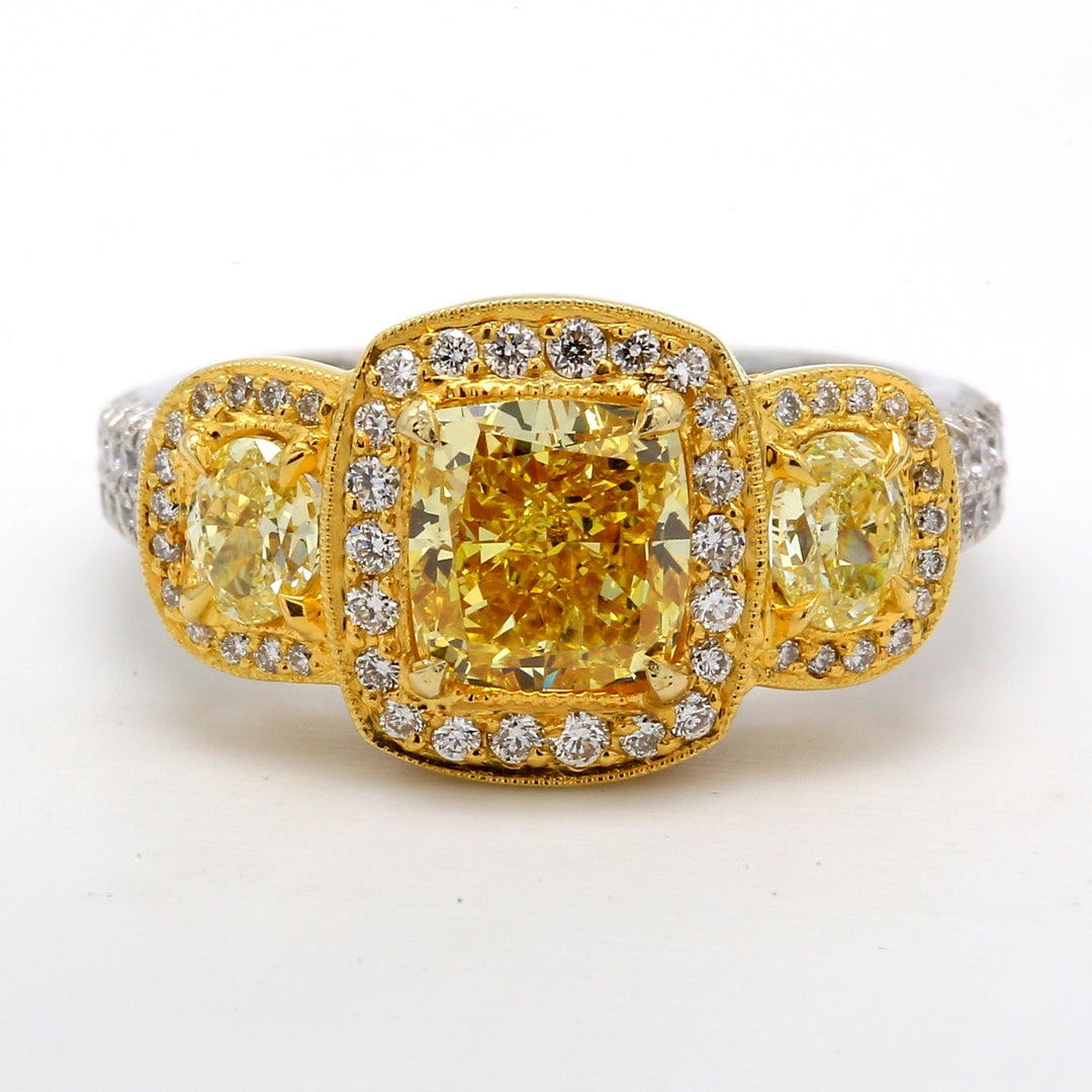 3-stone halo semi-mount in Platinum & 18K YG with fancy yellow oval sides, round diamonds around halo and shank, & heart design on gallery. D1.06ct.t.w.