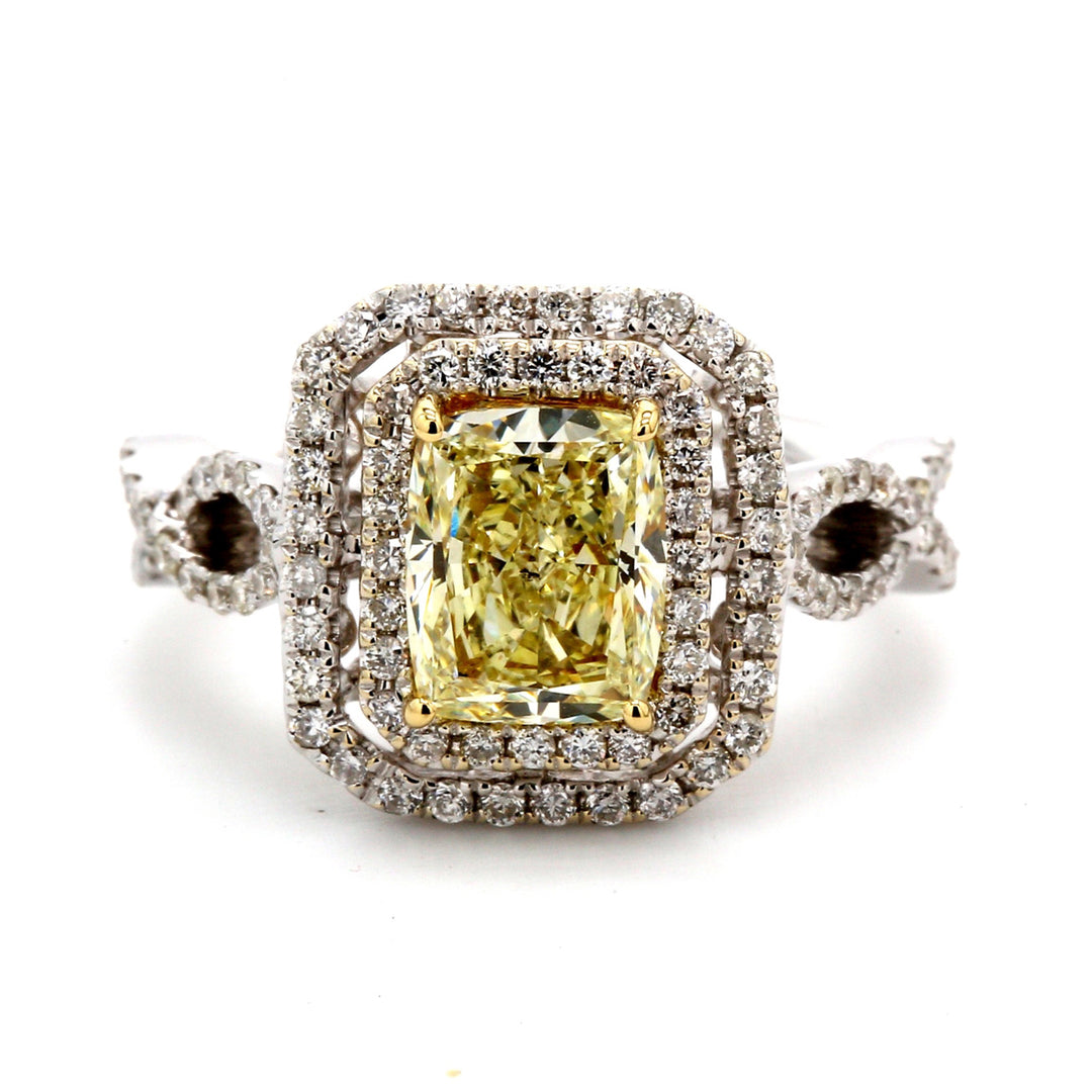 Double halo criss-cross shank ring in 18K WG with 4-prong set GIA certified FLY/SI2 radiant center & prong set round diamonds. D2.09ct.t.w. (Center 1.51ct.)