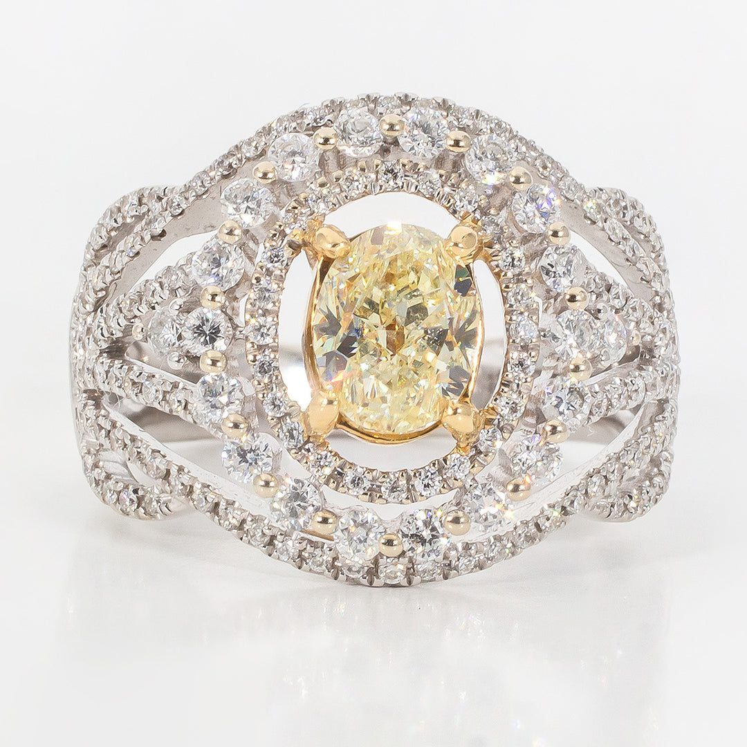 Double halo ring in 18K WG with prong set arounds around a FY oval diamond center stone. D1.89ct.t.w. (Center 1.08ct.)