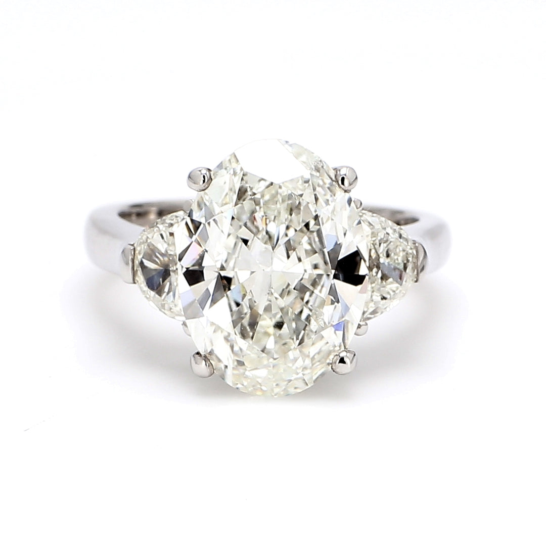 3-stone ring in 18K WG with GIA certified J/SI2 oval center and 3-prong set half moon diamond sides. D6.92ct.t.w. (Center 6.02ct.)