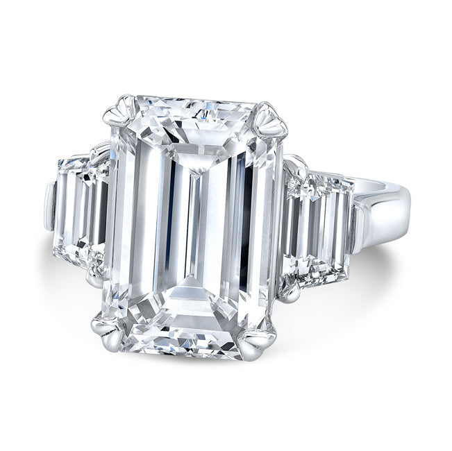 3-stone ring in platinum with GIA certified G/VS2 emerald cut center and step cut trapezoid diamond sides. D5.74ct.t.w. (Center 5.02ct.)
