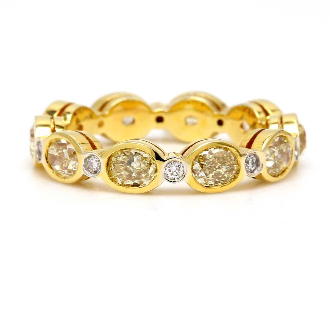 Eternity band in 18K YG with alternating bezel set rounds & fancy yellow oval diamonds. D3.29ct.t.w. Fancy Yellow 3.14ct.t.w. Size 7