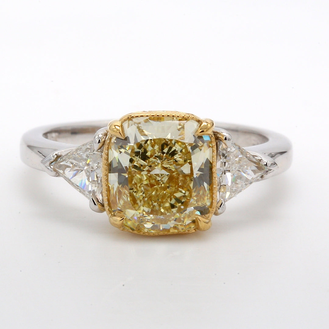 3-stone ring in platinum with GIA certified FLY/SI1 cushion cut center & trilliant cut diamond sides. D3.00ct.t.w. (Center 2.53ct.)