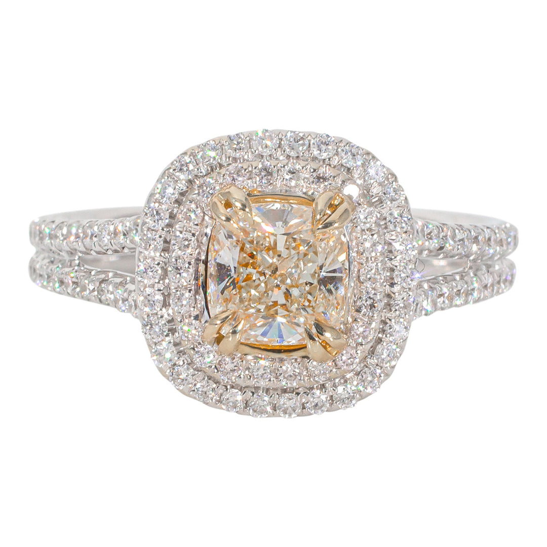Double halo split-shank ring in 18K WG with double 4-prong fancy yellow cushion cut center & prong set round diamonds. D1.37ct.t.w. (Center 0.90ct.) Size 6.5