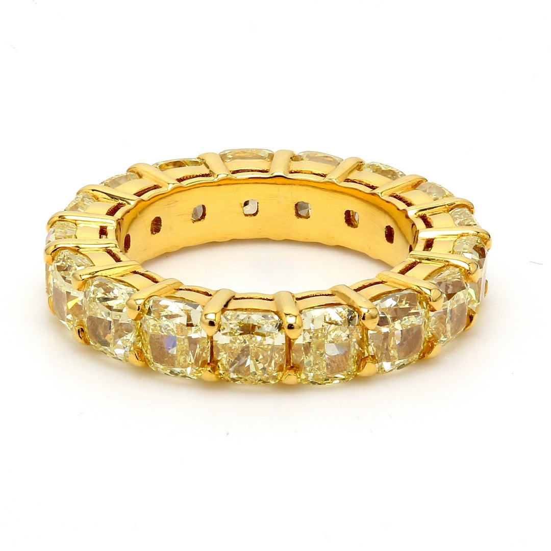 Eternity band in 18K YG with shared prong set (17) fancy yellow cushion cut diamonds. D6.89ct.t.w. Size 4.75