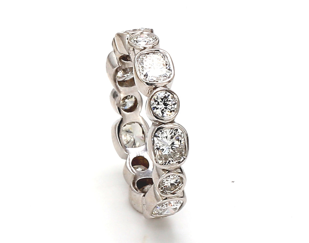 Eternity band with alternating bezel set (14) round and radiant cut diamonds. D2.72ct.t.w. Size 6