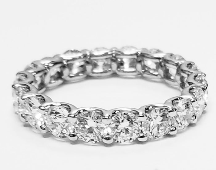 Eternity band in platinum with shared U-prong set E-F/VS round diamonds. D3.60ct.t.w. Size 5.5
