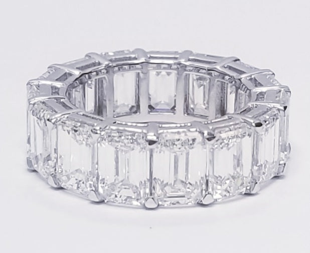 Eternity band in platinum with shared prong set white/VVS (15) emerald cut diamonds. D11.99ct.t.w. Size 5