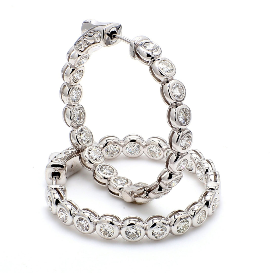 1.25"" Inside out hoop earrings with bezel set (34) round diamonds & with special spring lock. D3.26ct.t.w.
