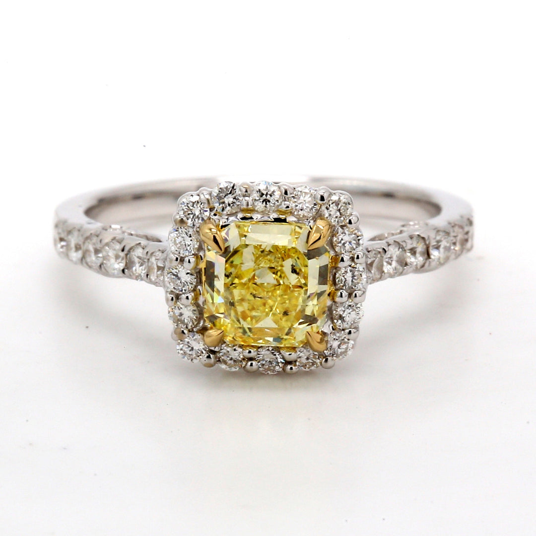 Halo fleur-de-lis style ring in 18K WG with French pave set rounds around 4-prong set GIA certified FIY/I1 radiant diamond centerstone. D1.50ct.t.w. (Center 1.02ct.)