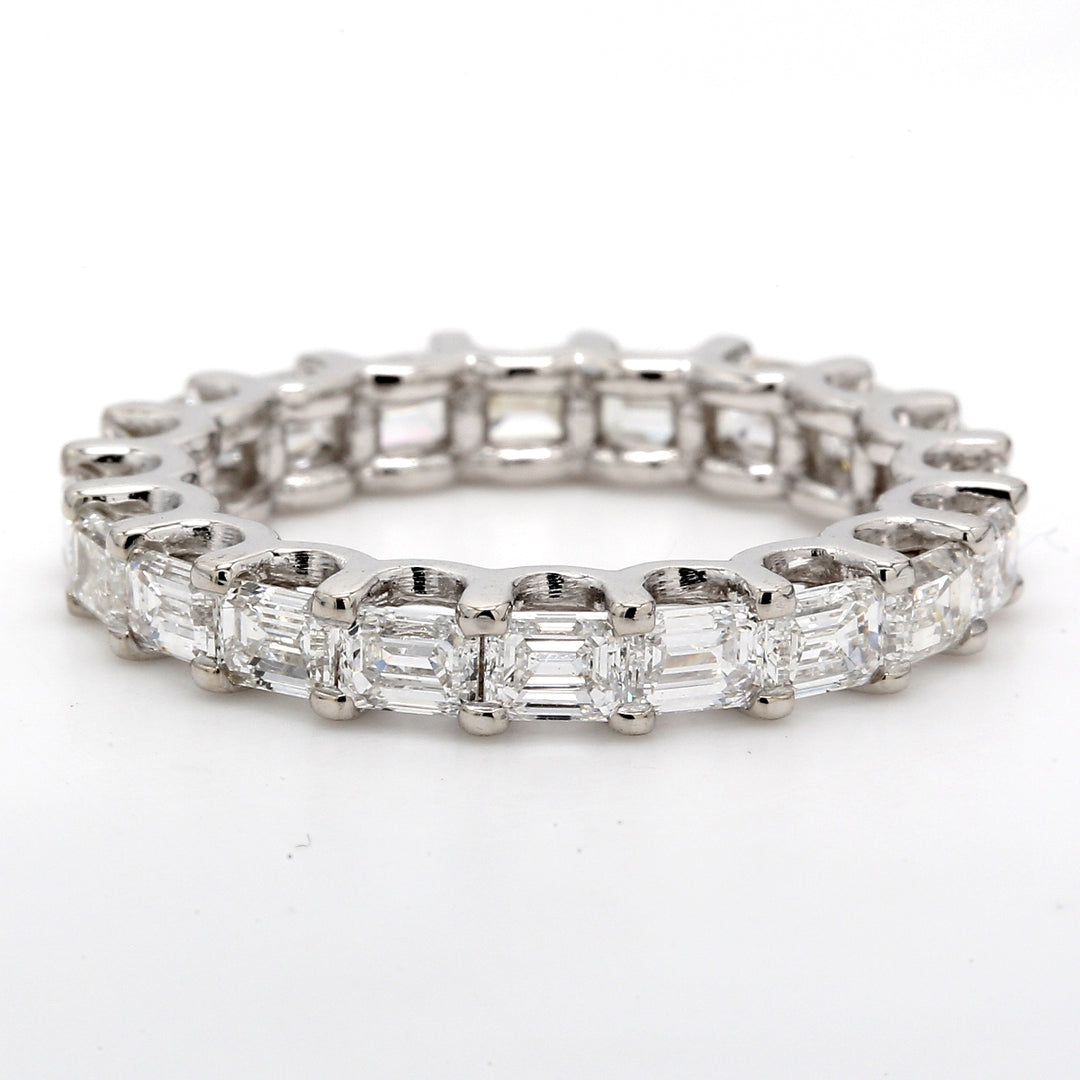 East to west style eternity band with shared U-prong set (20) emerald cut diamonds. D2.54ct.t.w. Size 5.5