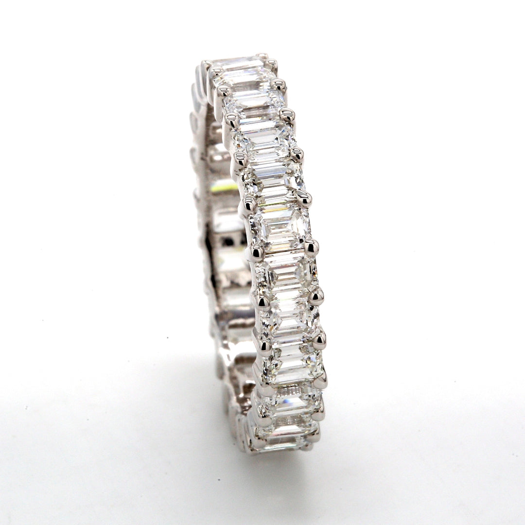 Eternity band in platinum with shared prong set (23) emerald cut diamonds. D4.49ct.t.w.
