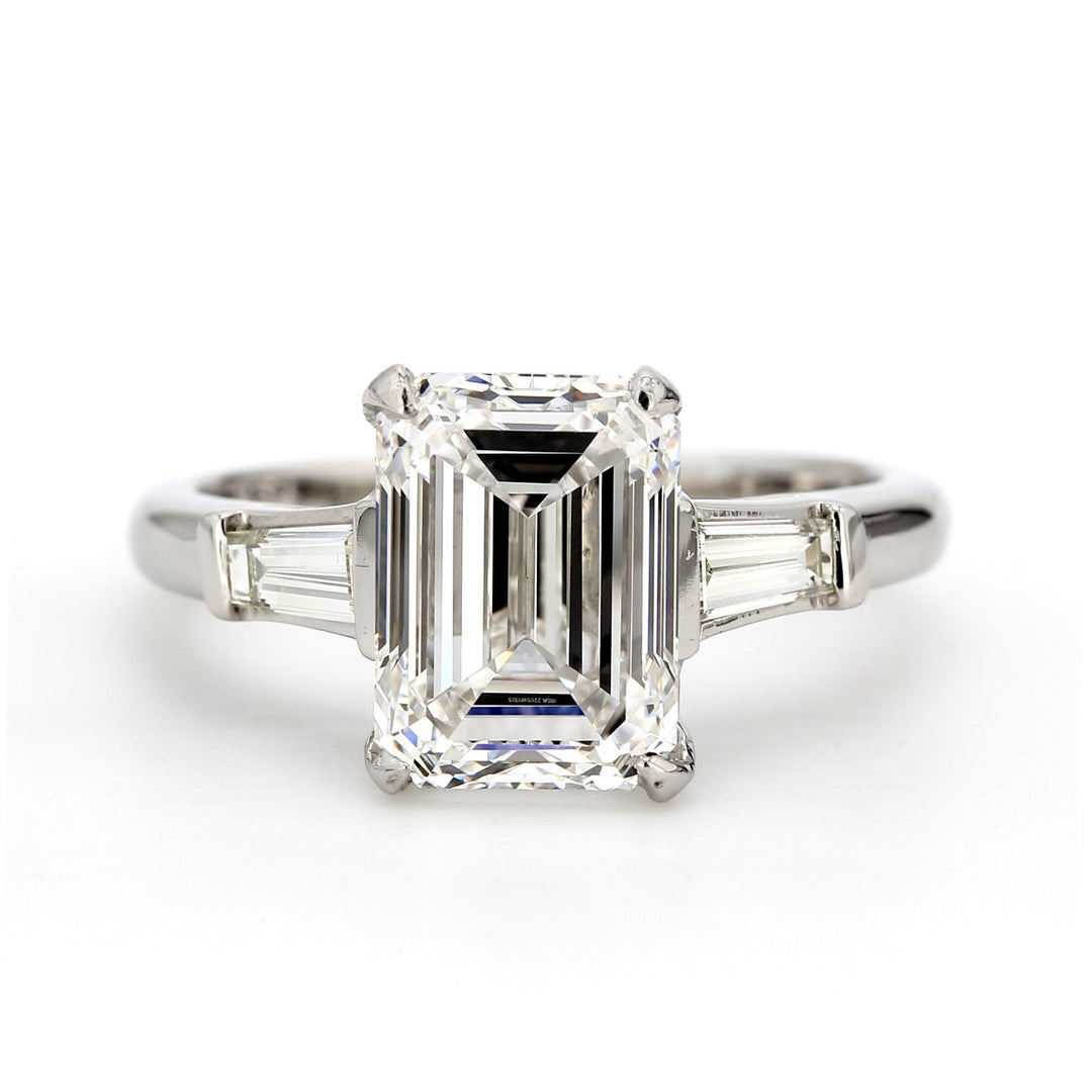 3-stone ring in platinum with GIA certified D/VS2 emerald cut center and channel set tapered baguette diamond sides. D4.54ct.t.w. (Center 4.19ct.)