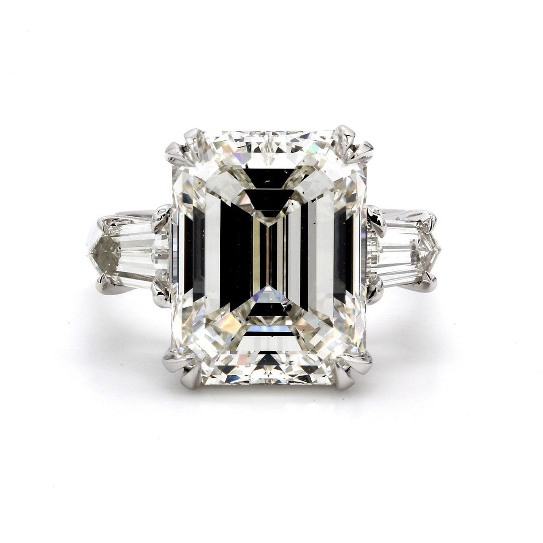 3-stone ring in platinum with double 4-prong set GIA certified I/SI1 emerald cut center and 4-prong set bullet diamond sides. D10.99ct.t.w. (Center 10.01ct.)
