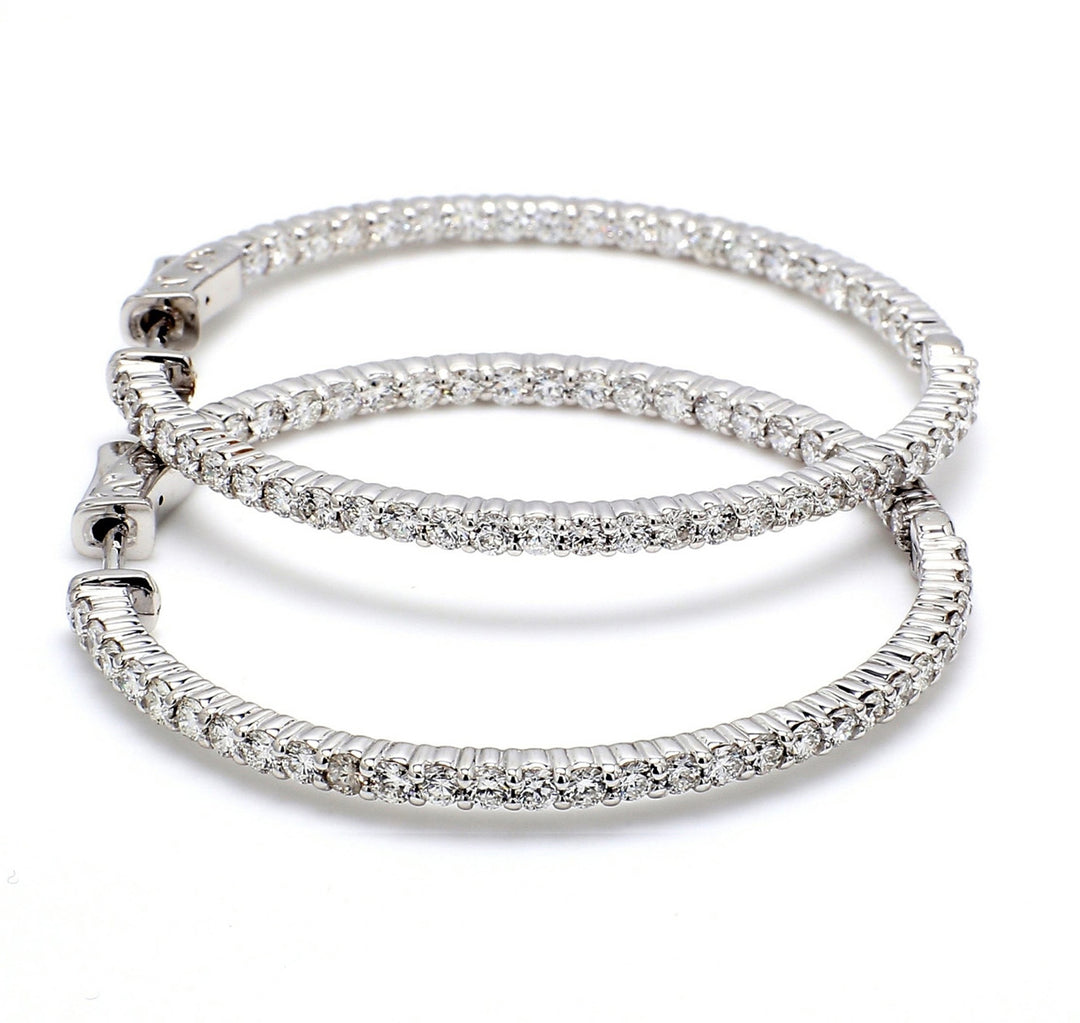 0.75"" Inside out hoop earrings with shared prong set round diamonds & with special spring lock. D1.11ct.t.w.