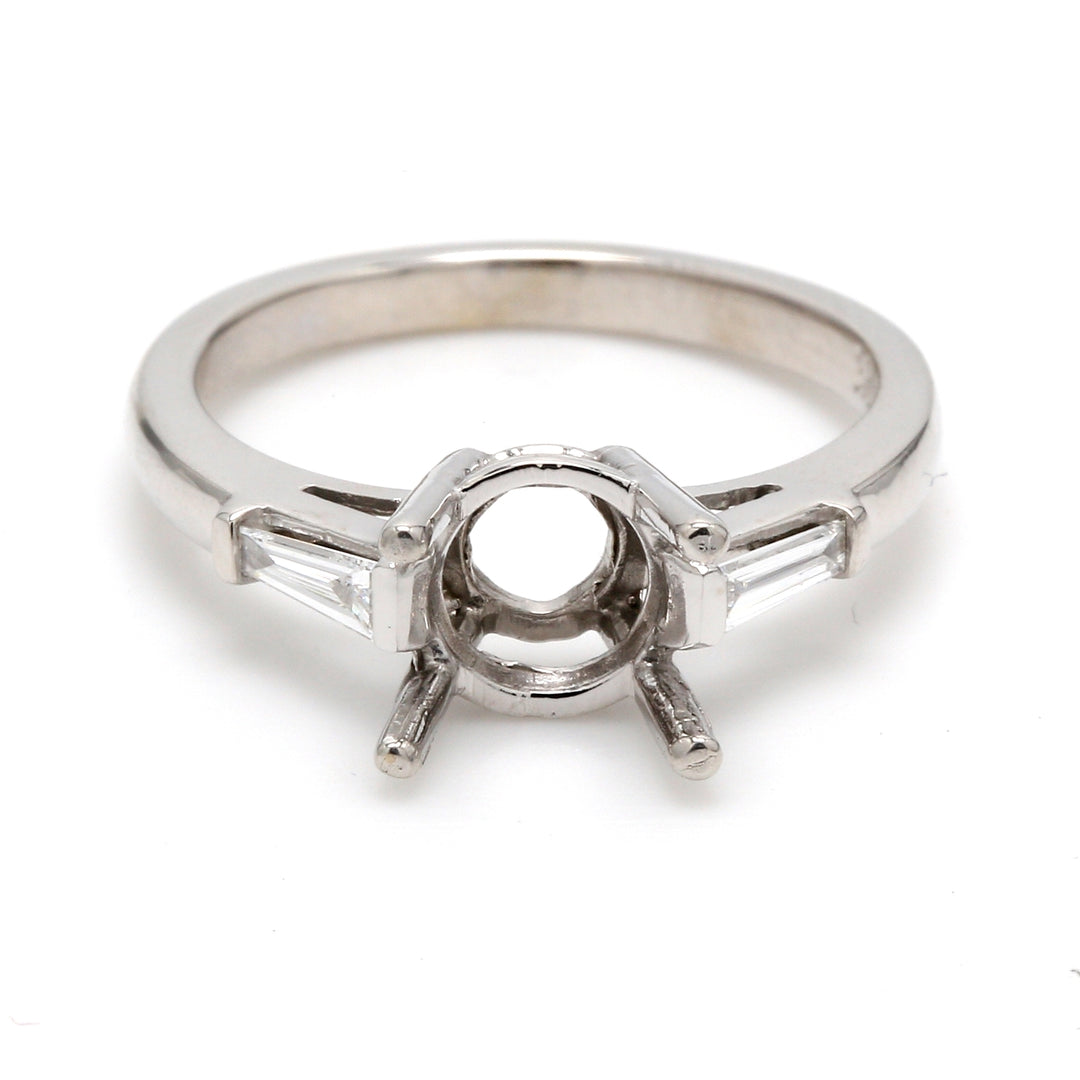 3-stone semi-mount with channel set tapered baguette diamond sides. D0.19ct.t.w.