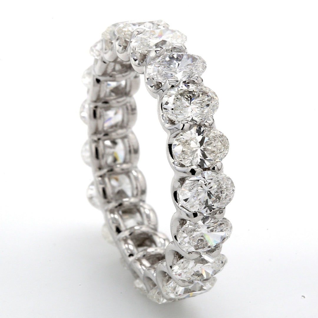 Eternity band in platinum with shared 4-prong set (19) oval cut diamonds. D4.32ct.t.w. Size 6