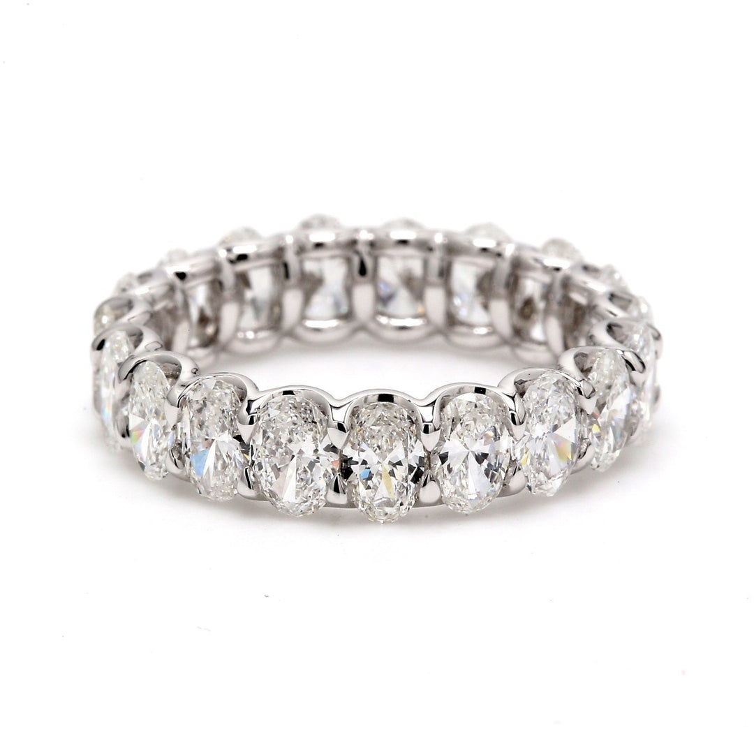 Eternity band in platinum with shared U-prong set (23) oval cut diamonds. D3.30ct.t.w. Size 5.25