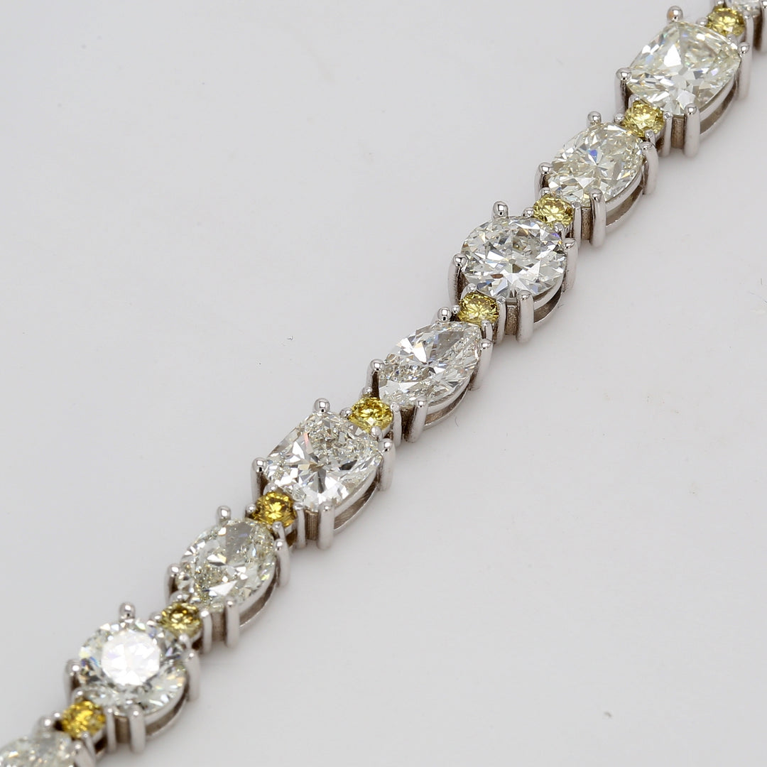 Tennis bracelet with alternating marquise, cushion, oval, rounds & prong set fancy yellow round diamonds. D15.55ct.t.w. Fancy Yellow 4.19ct.t.w.