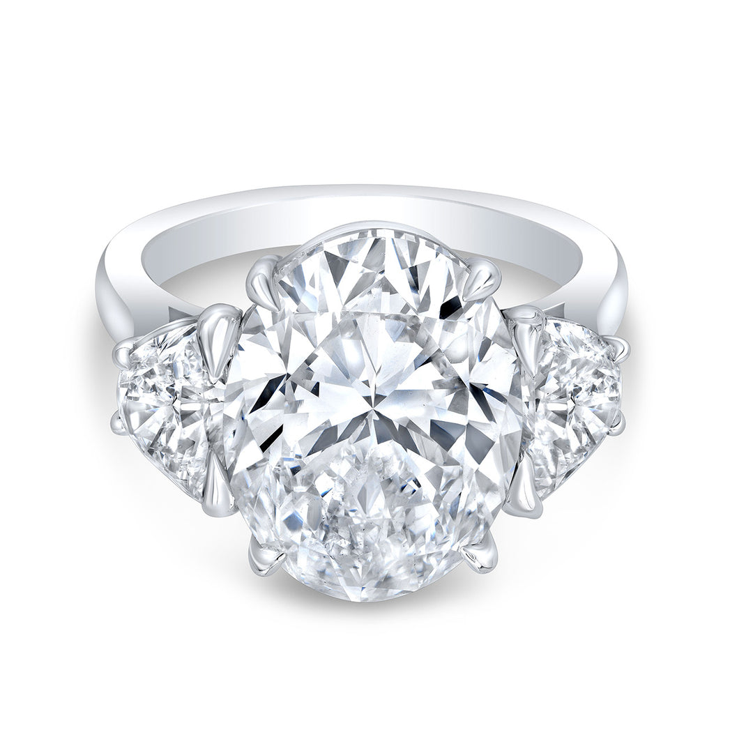3-stone ring in platinum with prong set GIA certified I/SI1 oval center and half moon diamond sides. D9.62ct.t.w. (Center 8.04ct.)