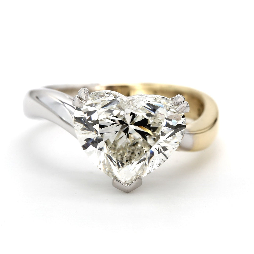 Solitaire ring in 18K two-tone with prong set GIA certified J/SI2 heart shape diamond center. D5.02ct.t.w.