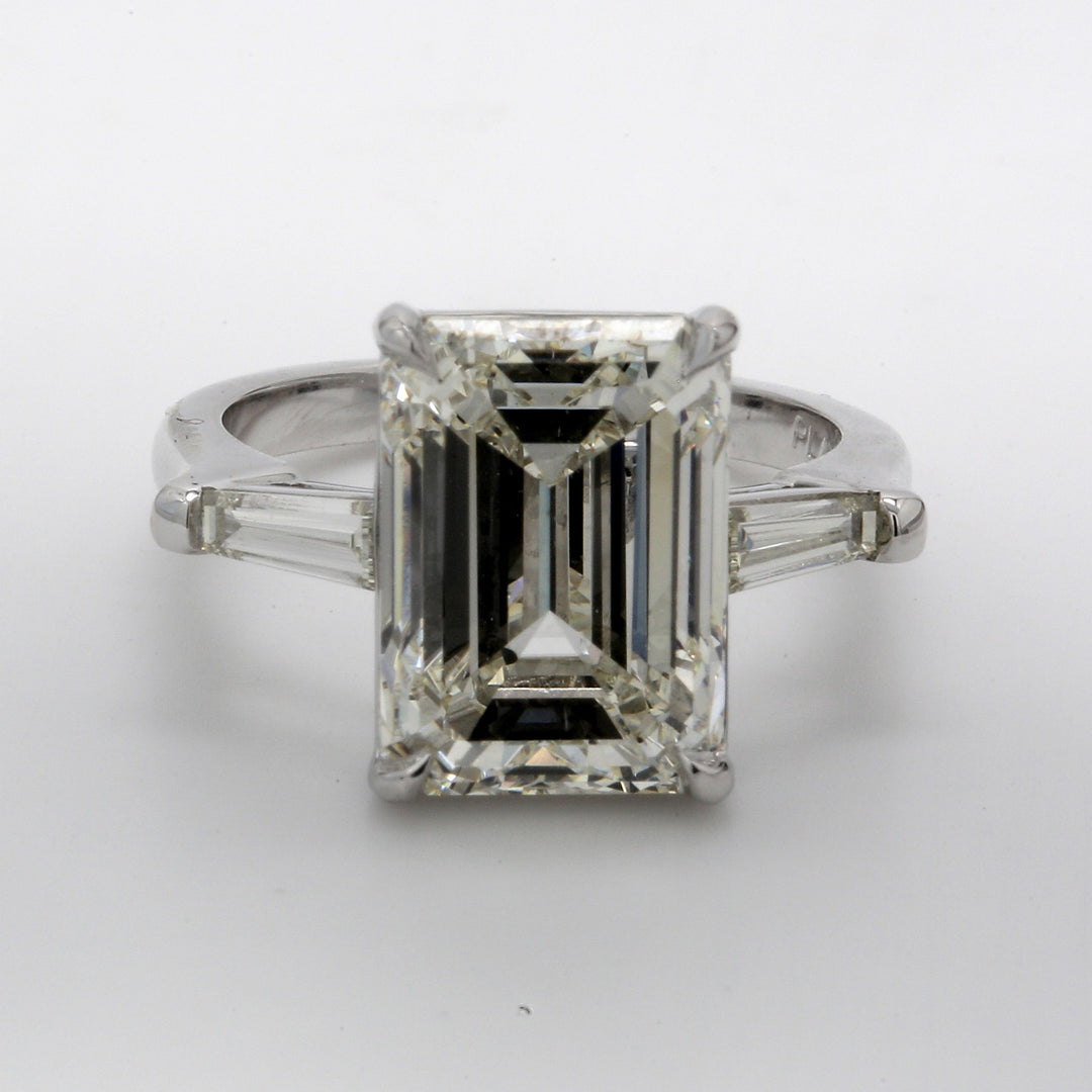 3-stone ring in platinum with prong set GIA certified L/VS2 emerald center and tapered baguette diamond sides. D8.47ct.t.w. (Center 8.02ct.) Size 5.75
