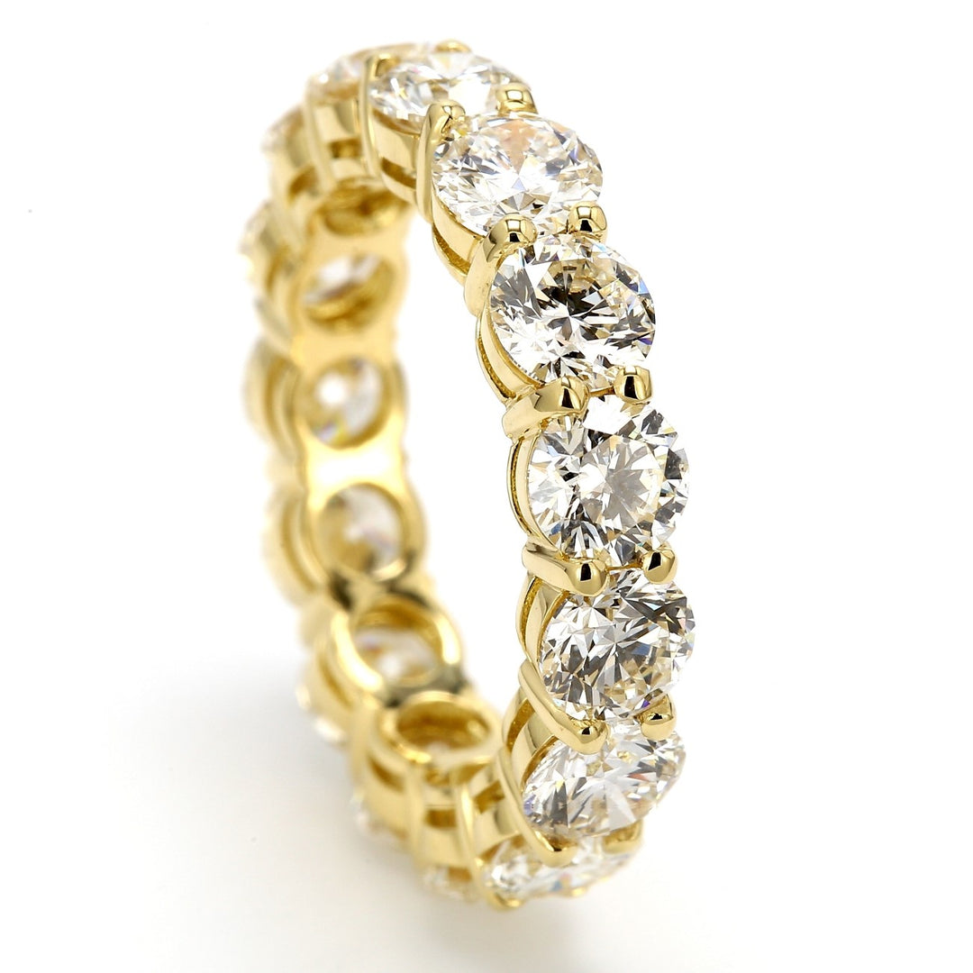 Eternity band in 18K YG with shared prong set round diamonds. D4.50ct.t.w. Size 5.25