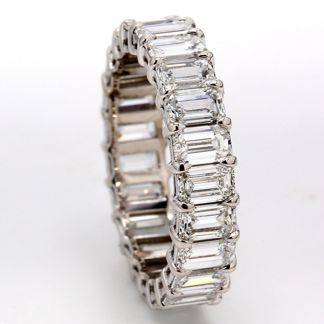 Eternity band in platinum with basket prong set (23) emerald cut diamonds. D5.22ct.t.w. Size 7