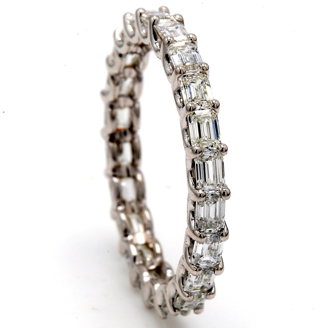 Eternity band east to west style in 18K WG with U-prong set (23) emerald cut diamonds. D2.00ct.t.w. Size 7