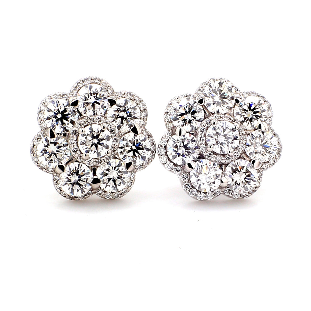 Flower design push back earrings with pave set rounds around prong set round diamonds. D5.02ct.t.w.