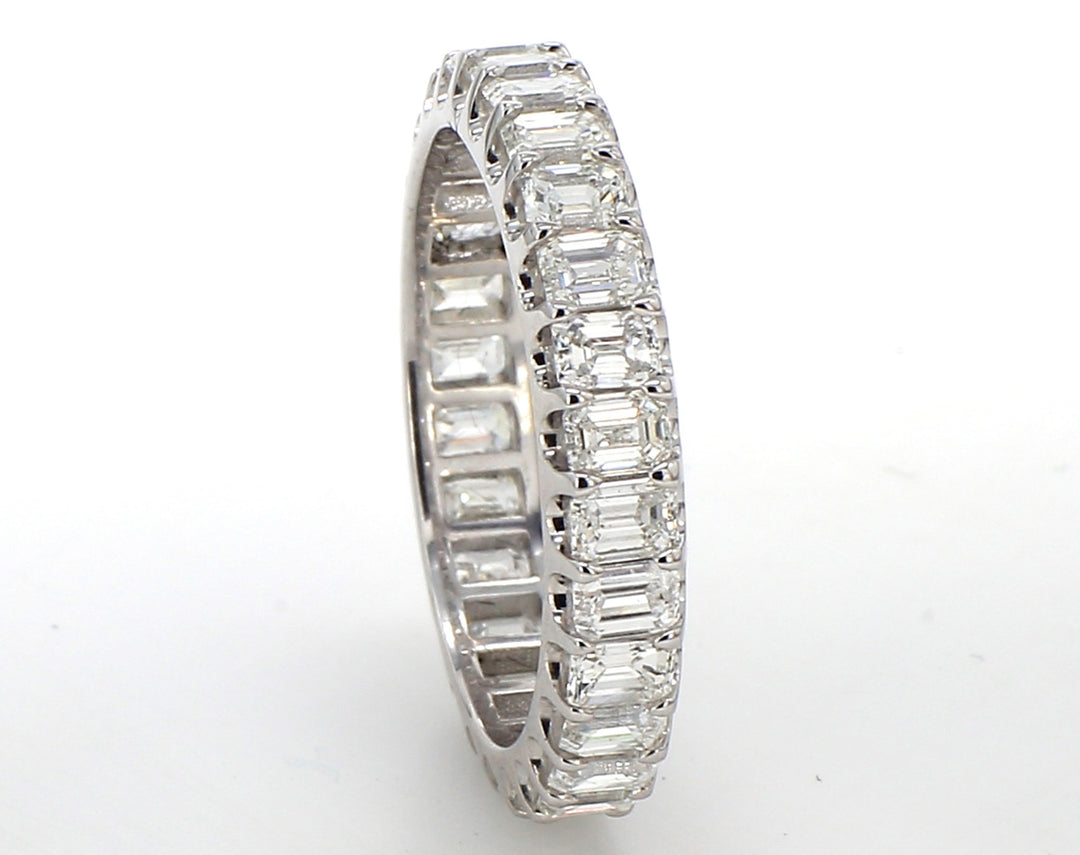 Eternity band in platinum with U-prong set (28) emerald cut diamonds. D2.81ct.t.w. Size 6.5