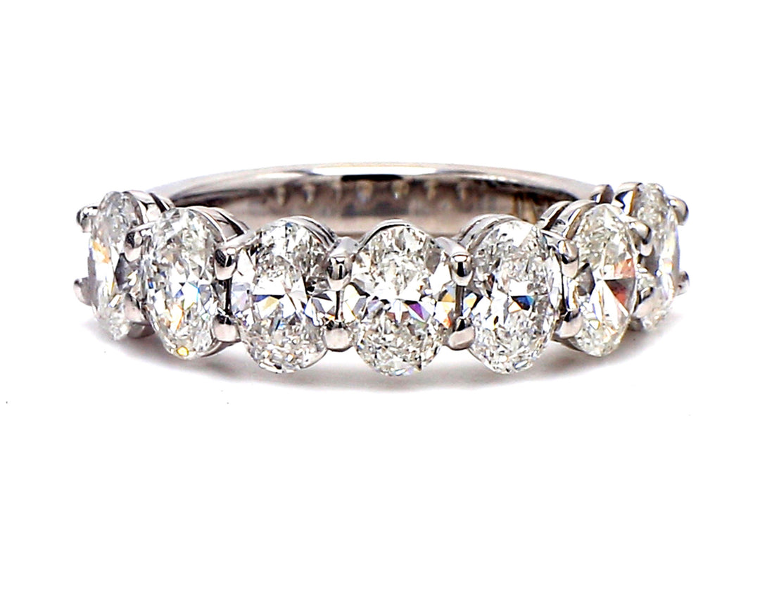 7-stone band in platinum with basket prong set oval cut diamonds. D2.17ct.t.w. Size 6