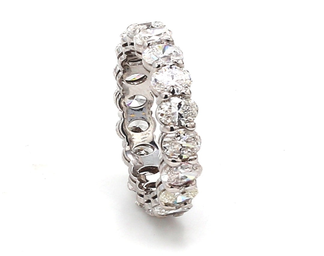 Eternity band in platinum with basket prong set (18) oval cut diamonds. D3.35ct.t.w. Size 4.75