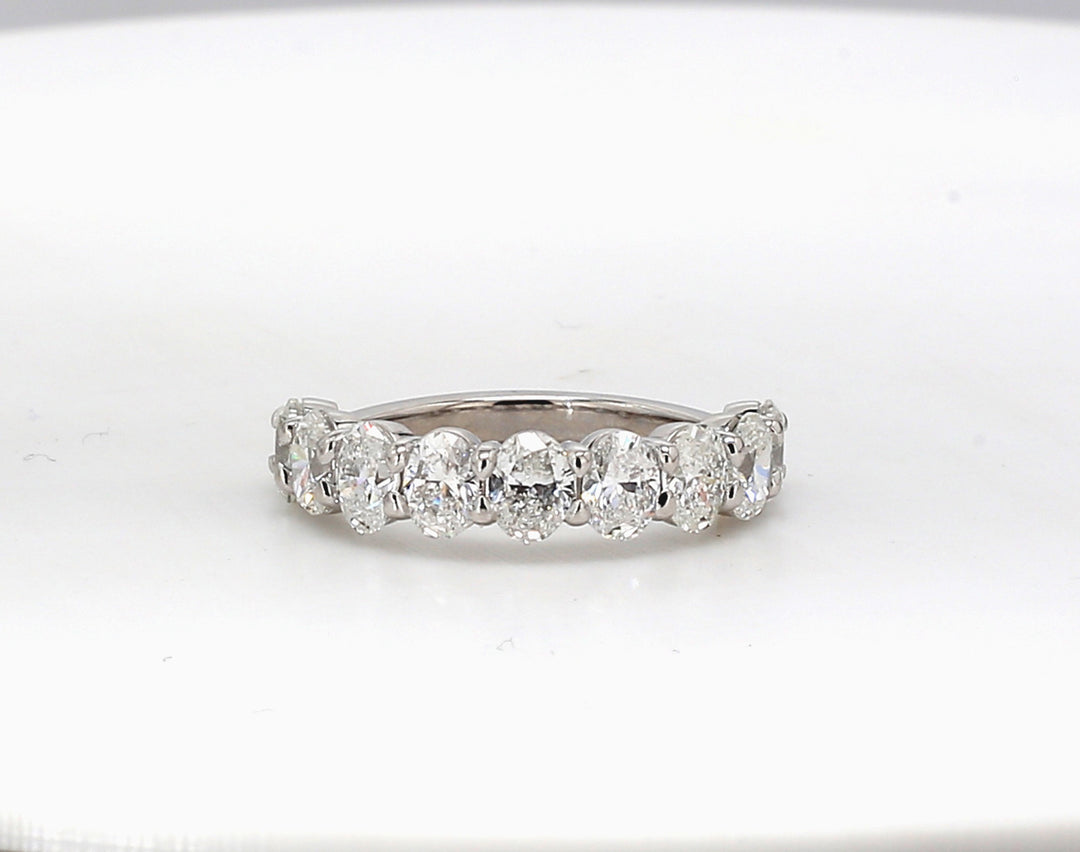 9-stone band in platinum with shared prong basket set oval diamonds. D2.27ct.t.w. Size 6