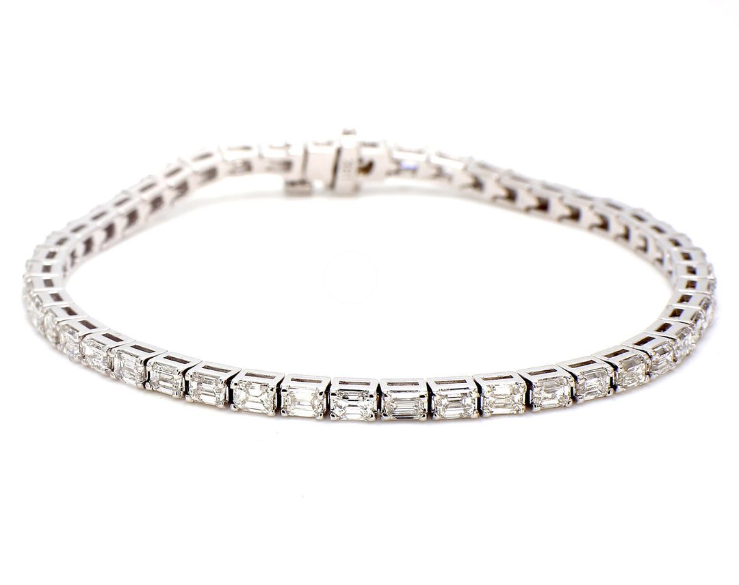 7"" Tennis bracelet east to west style in 18K WG with basket prong set (47) emerald cut diamonds. D5.56ct.t.w.