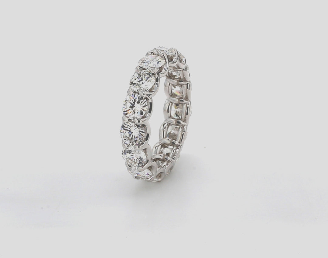 Eternity band in platinum with shared u-prong set E-F/VS1-SI1 (15) round diamonds. D5.47ct.t.w. Size 7.25