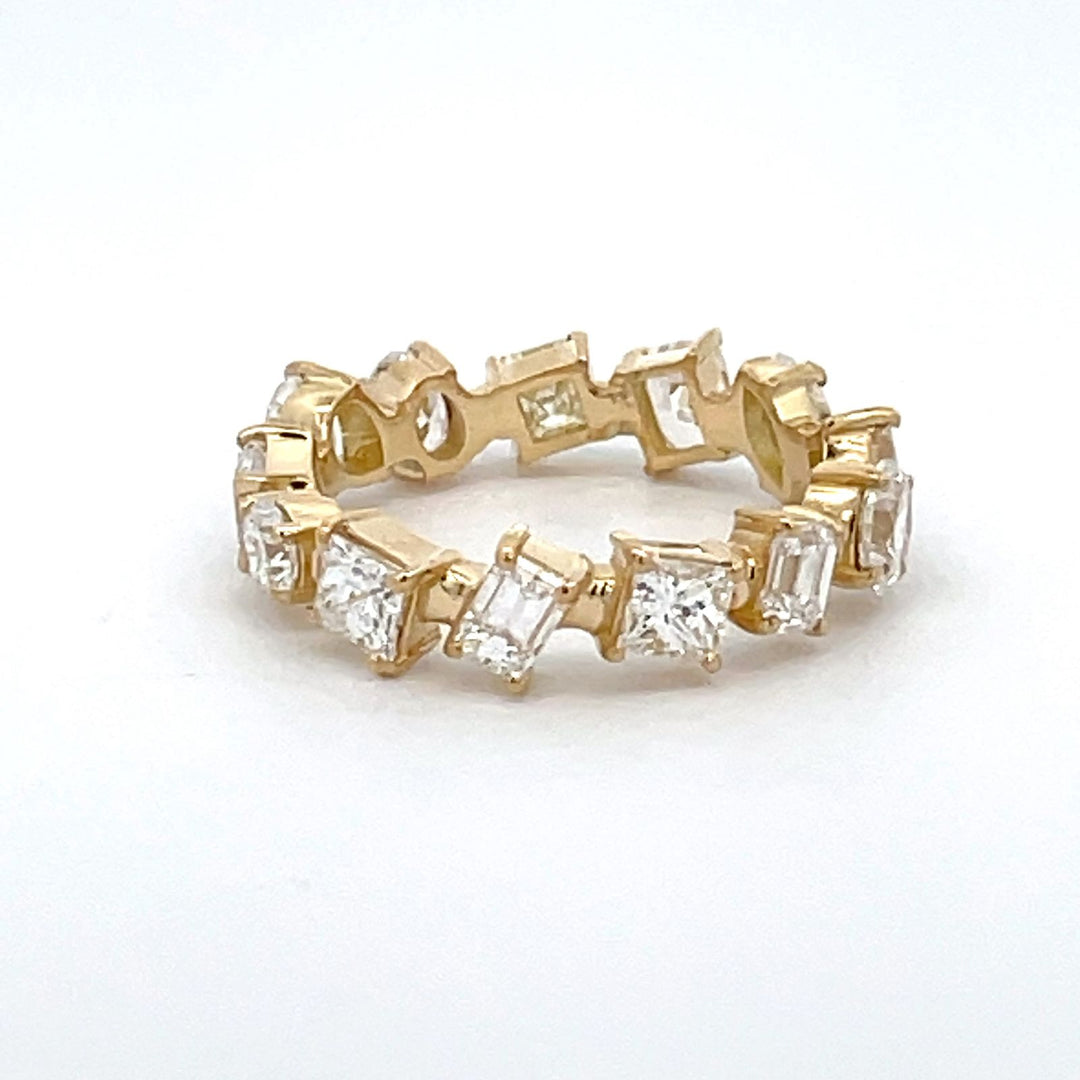 Eternity band in 18K YG with 4-prong set multi shape diamonds. D2.48ct.t.w. Size 5.75