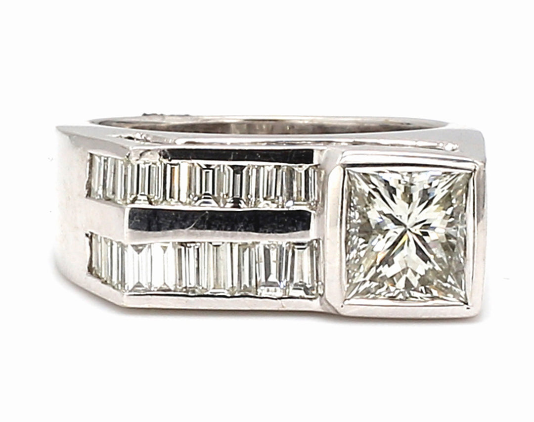 Flat top ring in 18K WG w/ 2-row channel set baguettes & princess cut diamond center stone.  D4.73ct.t.w.  (Center - 2.23ct.)