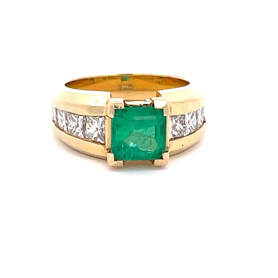 Ring in yellow gold with channel set graduated princess cut diamonds on the shank & emerald center.  D1.80ct.t.w.  (Emerald - 1.86ct.)