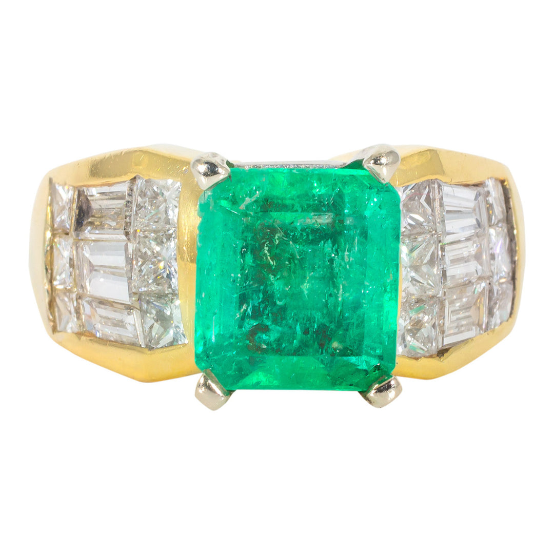 Ring in 18K YG with 3-row invisible set combination princess cut and baguette diamonds, and emerald center stone.  D1.80ct.t.w.  Emerald 2.05ct.