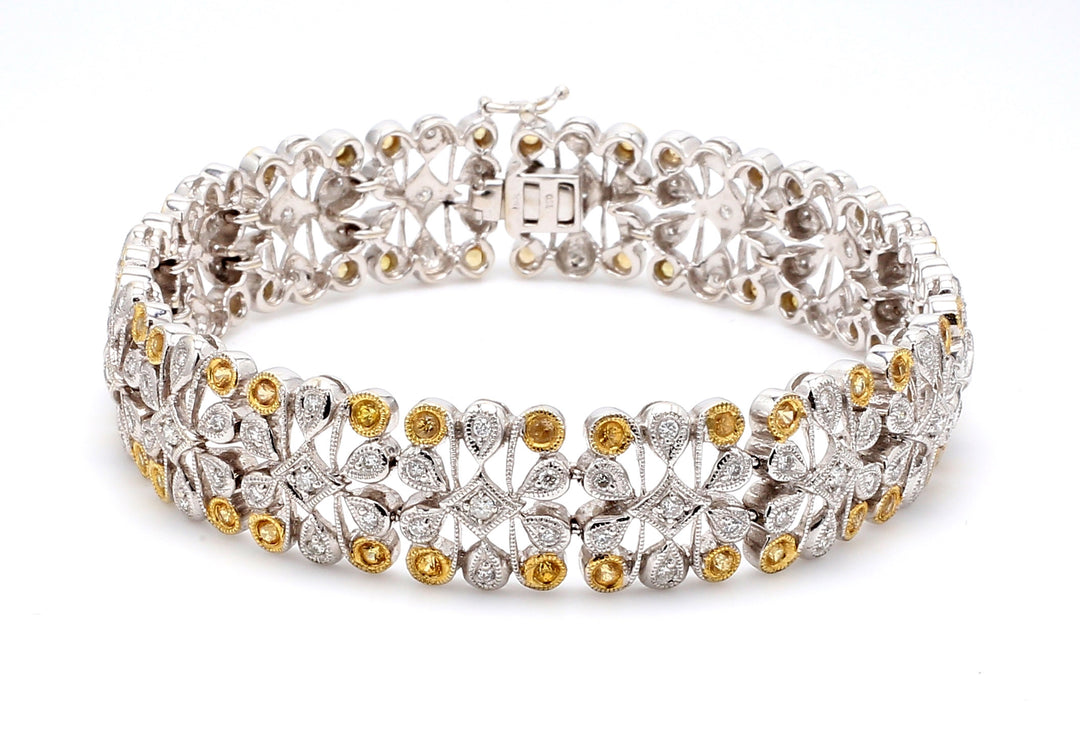 Art deco style bracelet in 18K two-tone with round diamonds & yellow sapphires.  D1.36ct.t.w.  Yellow Sapphires 0.99ct.t.w.